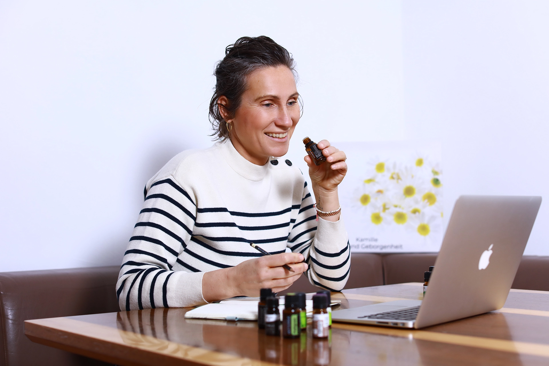 Teilnehmerin riecht an einem ätherischen Öl während eines Aromatherapie Online Kurses und lernt die Anwendung ätherischer Öle in der Praxis.
